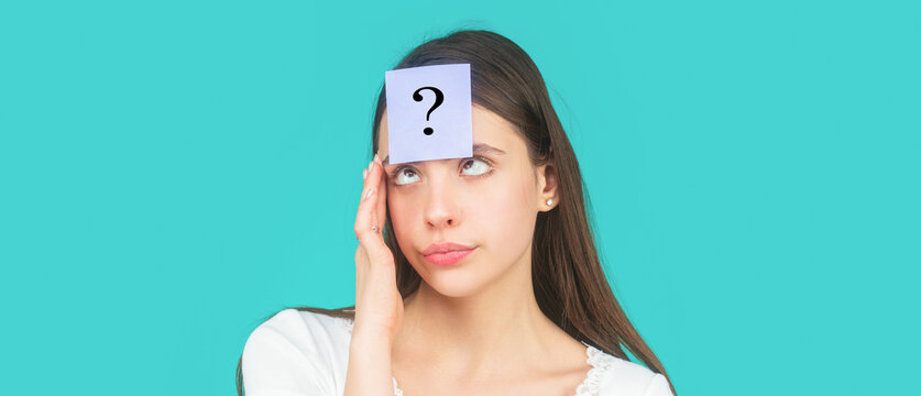 Paper notes with question marks. Doubtful girl asking questions to himself. Confused female thinking with question mark on sticky note on forehead. Thinking woman with question mark looking up
