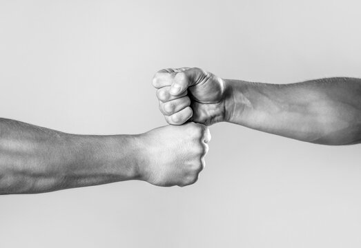 Hands of man people fist bump team teamwork, success. Man giving fist bump. Team concept. People bumping their fists together, arms. Friendly handshake, friends greeting. Two hands, isolated arm