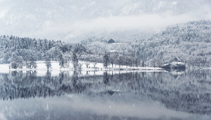 Bohinj lake in winter time with snow and the clouds
