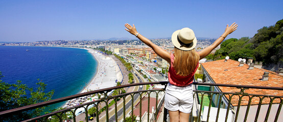Traveling in France. Panoramic view of beautiful girl with open arms on Nice city, French Riviera.
