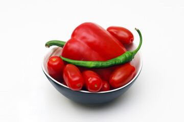 Fresh peppers and cherry tomatoes on a white background. Close-up