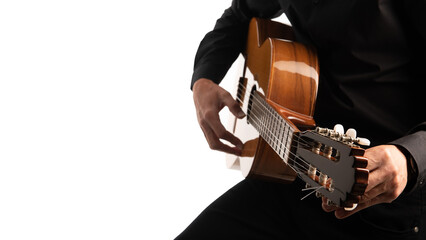 Isolated guitar and guitarist's hands close up.  Tuning an acoustic guitar on a white background with copy space