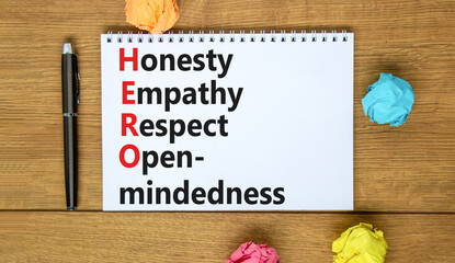 HERO honesty empathy respect open-mindedness symbol. Concept words HERO honesty empathy respect open-mindedness on the note on wooden background. HERO honesty empathy respect open-mindedness concept.