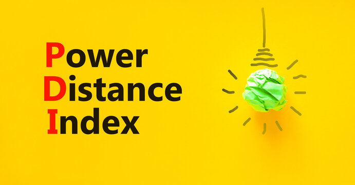 PDI power distance index symbol. Concept words PDI power distance index on yellow paper on a beautiful yellow background. Green light bulb icon. Business PDI power distance index concept. Copy space.