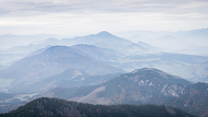 Autumn landscape with forests and mountains disappearing in fog, Slovakia, Europe