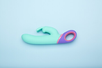 multi-colored sex toy, adult toy on a blue background - obrazy, fototapety, plakaty