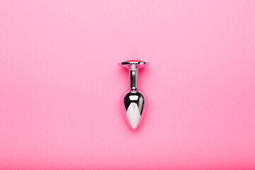 metal sex toy on a pink background, a toy for adults - obrazy, fototapety, plakaty