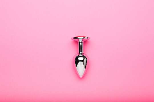metal sex toy on a pink background, a toy for adults