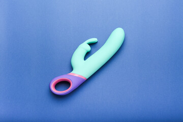 multi-colored sex toy, adult toy on a blue background