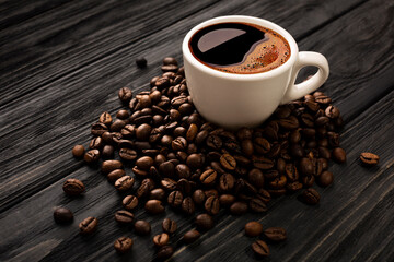 Coffee with beautiful foam with coffee beans on black boards