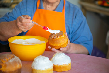 one grandmother smears Easter cake with protein cream