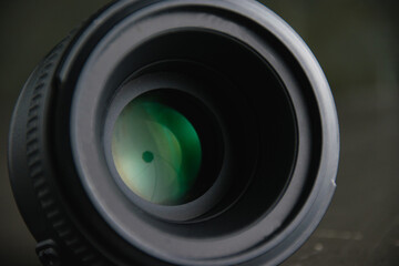 Fototapeta na wymiar Lens on a dark gray background. The concept of using photographic equipment