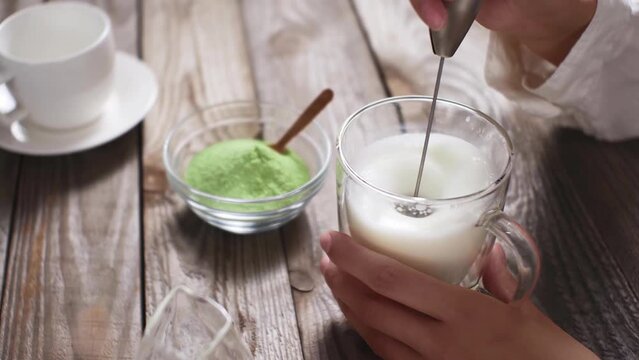 Matcha tea bright green plant based milk preparation drink, Mixer froth milk to make green tea from natural organic ingredients, vegetarian drink lactose free plant milk
