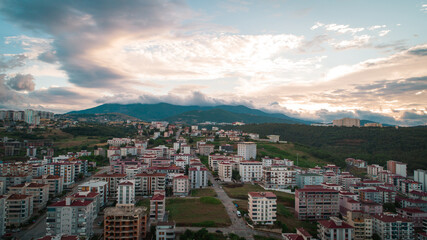 A view of a large mountain and Ondokuz Mayıs University behind the city streets, taken with a drone from the Atakum district of Samsun.