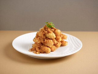 crispy fried eggplant with pork floss served in a dish isolated on background side view