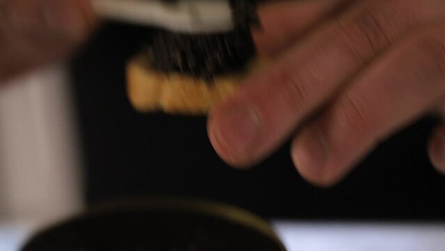Close up hand picks a spoonful of black caviar. black caviar on the spoon