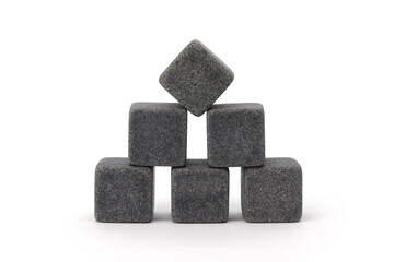 Pile of multiple whiskey cooling stone cubes composition isolated over the white background