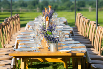 Lavander flower table decorations for holidays and wedding dinner. Wedding table decoration in rustic style with lavander