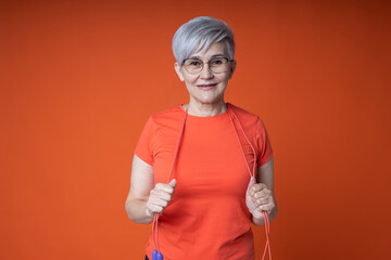 stylish woman in glasses goes in for sports with a skipping rope
