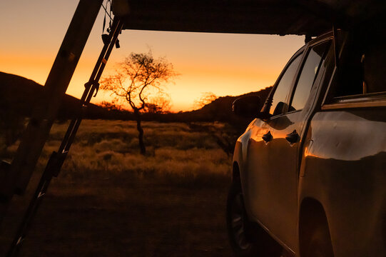 Car with roof tent camping in sunset in Namibia Africa
