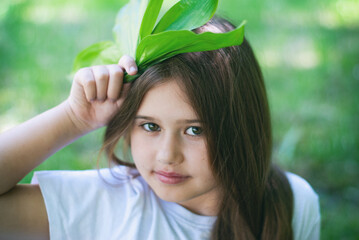 Beautiful little girl with green plants