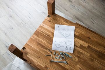 tools and instructions for assembling a wooden table