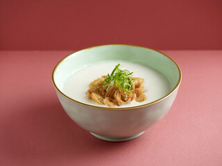 plain congee served in a dish isolated on mat side view on grey background
