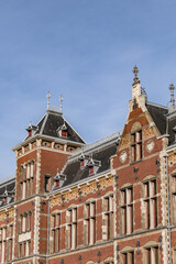 Architectural fragments of historic building of Amsterdam central railway station (1889). Amsterdam, the Netherlands.