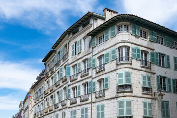 Bayonne in the pays Basque, typical facades with colorful shutters in the historic center
