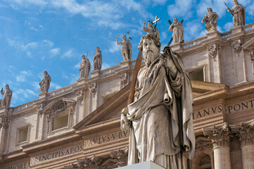 Renaissance sculpture of Apostle Paul with a sword in front of the St Peter's Basilica, Vatican, Rome, Italy. Detail of the facade exterior on the blue sky background. 