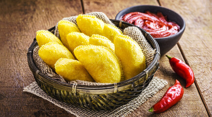 Colombian empanada, wheat flour pastry stuffed with meat and served with spicy sauce, typical of colombia, south america