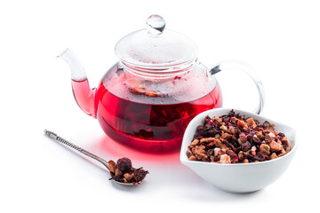 Hot fruit tea in glass teapot isolated on white