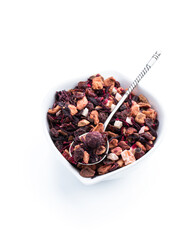 Dry fresh fruit tea in small ceramic bowl isolated on white