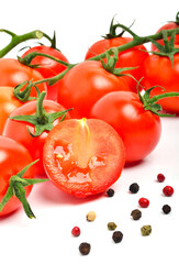 Cherry tomatoes with peppercorns isolated on white background.
