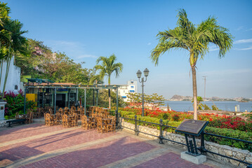 Obraz premium Guayaquil, Guayas, Ecuador - November, 2013: An empty outdoor restaurant, surrounded by palm trees, on they way up to the Lighthouse, with a beautiful view of the Guayas River. Sunny afternoon.