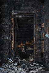 Wooden building after the fire. Burnt walls and ceiling