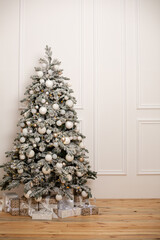 White Christmas tree on wooden flour