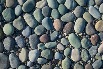 Colored blue and yellow sea stones background. Top view