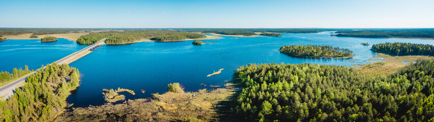 Aerial view on Karelian lake Lindozero. Lake in Karelia in summer. Blue lake and green forest top view