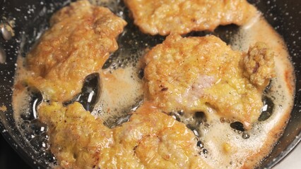 Fry meat in oil in frying pan.