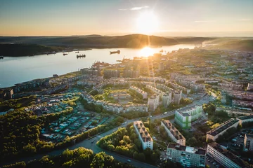 Schilderijen op glas Aerial view of Murmansk in the summer. City beyond the Arctic Circle. Polar day © Alexey Oblov