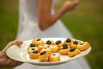 Small Cookies Filled With Poppy Seeds and Cheese with Raisins. Traditional Czech Wedding Sweets on White Plate.