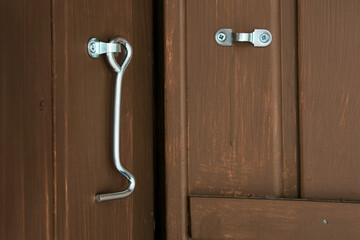 Steel hook for locking doors in utility rooms.