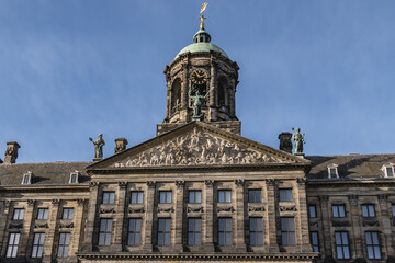Architectural fragments of Amsterdam Royal Palace building (Koninklijk Paleis) at Dam Square. Classicism style Palace built as city hall during Dutch Golden Age (1648 - 1655). Amsterdam, Netherlands.