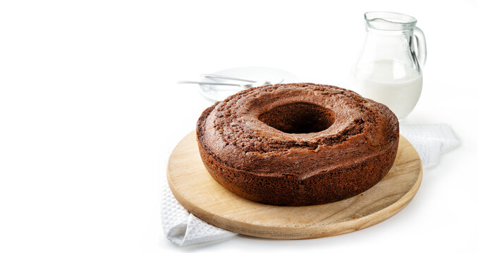 Chocolate donut with milk carafe isolated on white background.