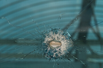 bullet hole in glass - authentic shot - closeup isolated on white.