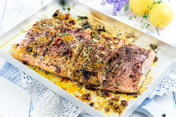 Traditional German salmon filet with herbs and spice served as close-up in a silver tray PRO05696
