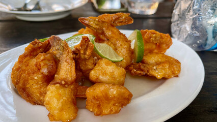 Batter fried sesame prawns with lime