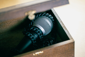 Mic all in chains inside a wooden box