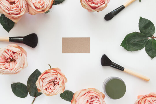 Make-up artist layout design for social media. Pink roses, brushes and card on white background